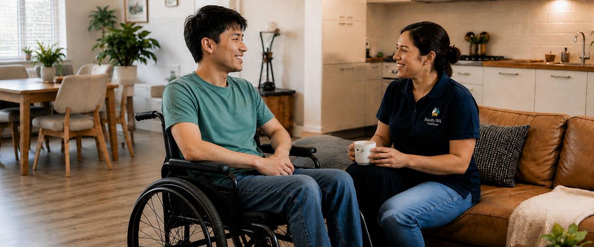 Support worker speaking with a client in a living room